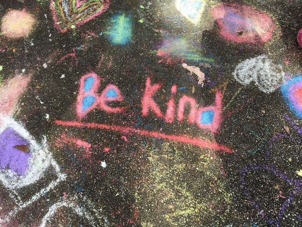 Chalkboard surface with the words "be kind" written